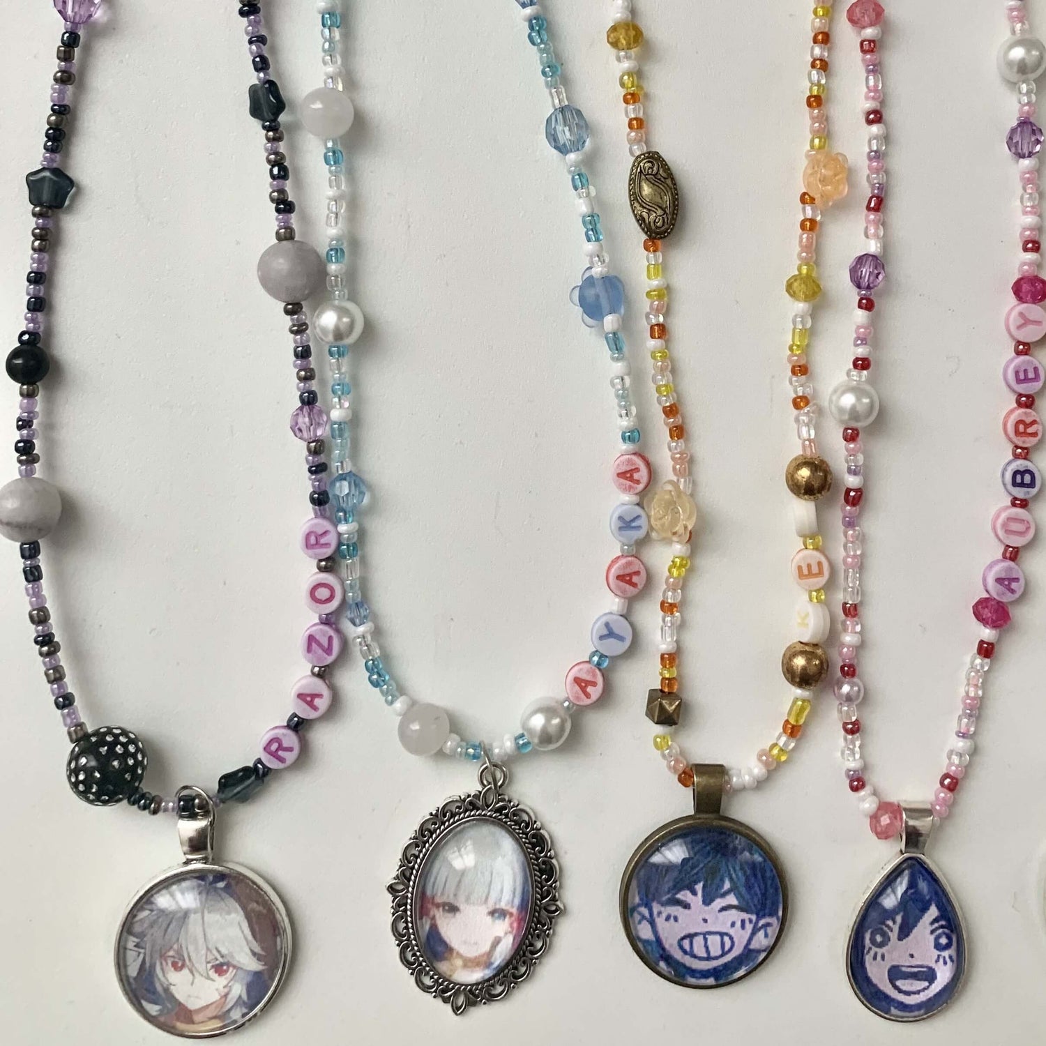 4 character necklaces lie flat